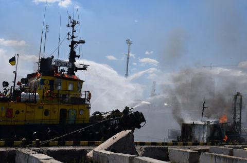 Firefighters work at the site of a Russian missile strike in a sea port of Odesa, Ukraine, on July 23.