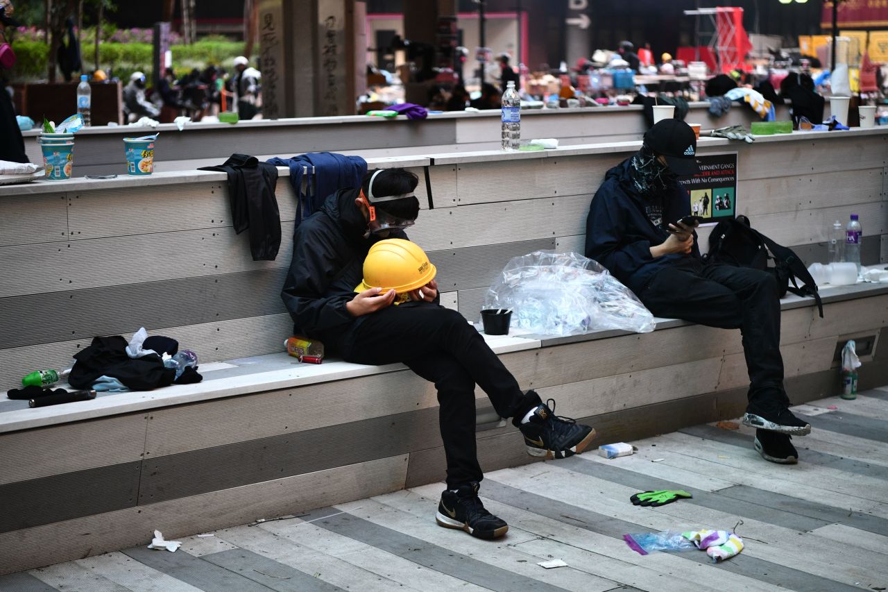 Protesters rest during a lull in clashes at the Hong Kong Polytechnic University and in Hung Hom district on November 18.