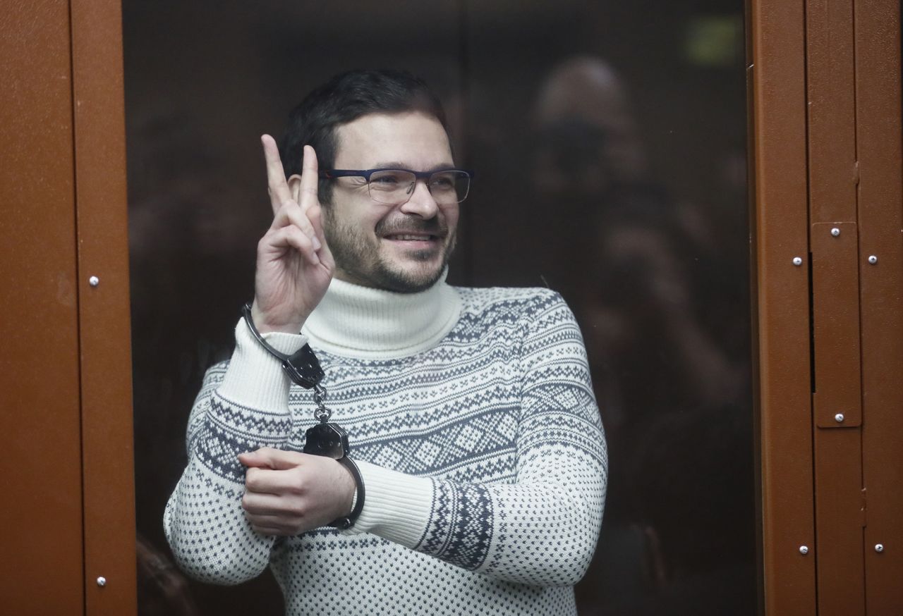 Russian opposition activist Ilya Yashin gestures as he stands inside a glass cubicle in a courtroom, prior to a hearing in Moscow, Russia, on December 9.
