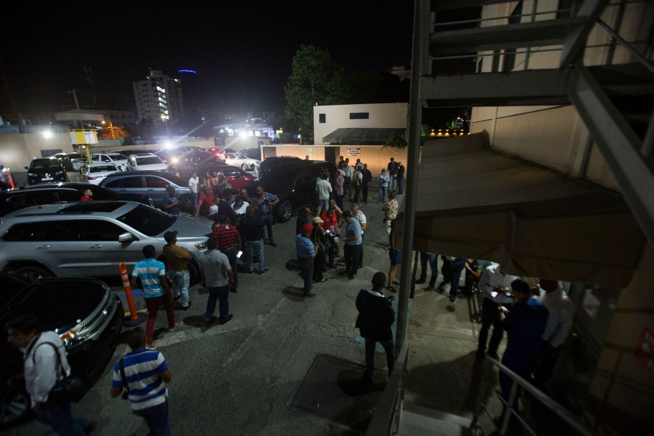 Journalists gather outside the clinic where David Ortiz was treated last night after being shot 