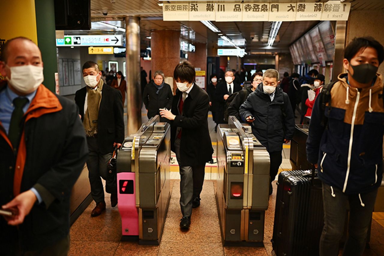 Commuters pass through a train station in Tokyo's Ginza district on Monday, February 17.