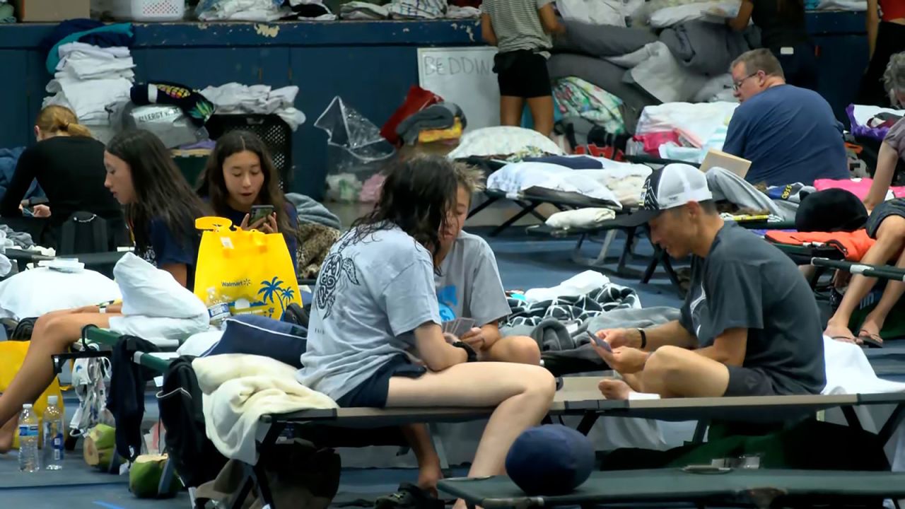 People evacuated from the fires take refuge in a an emergency shelter.