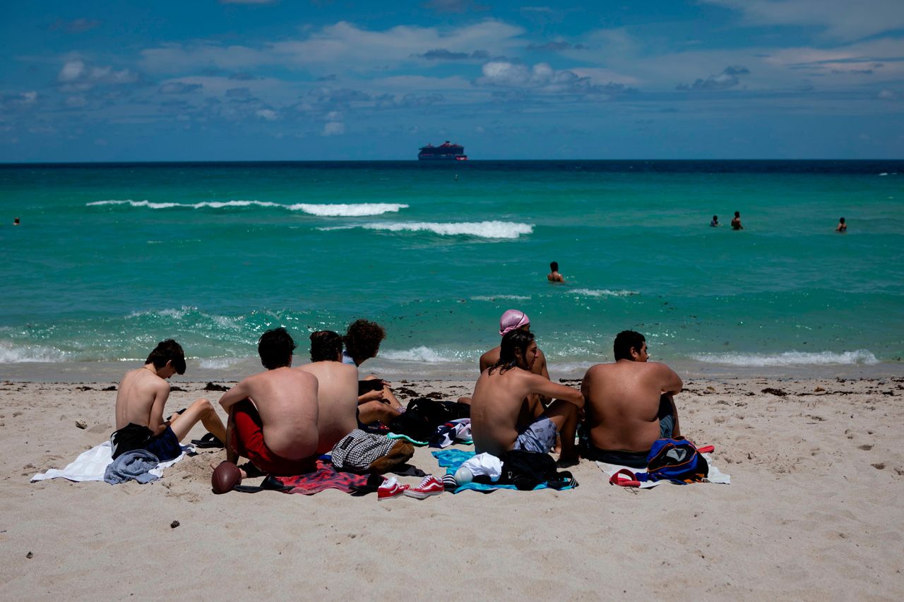 Beachgoers sunbathe in Miami Beach, Florida on June 16, 2020.