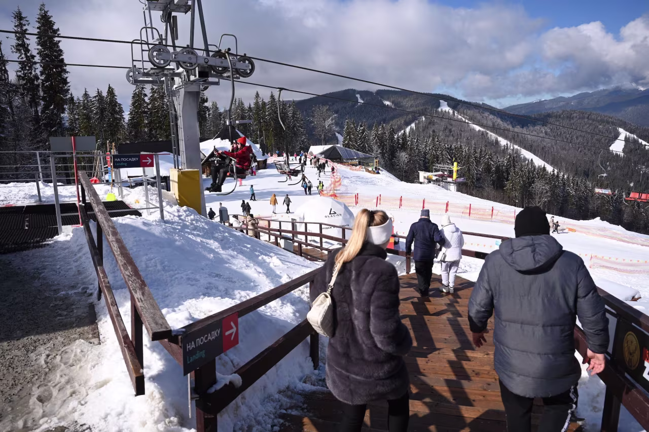 Tourists stroll in a ski resort close to Bukovel town, southwest from capital Kyiv on March 1.