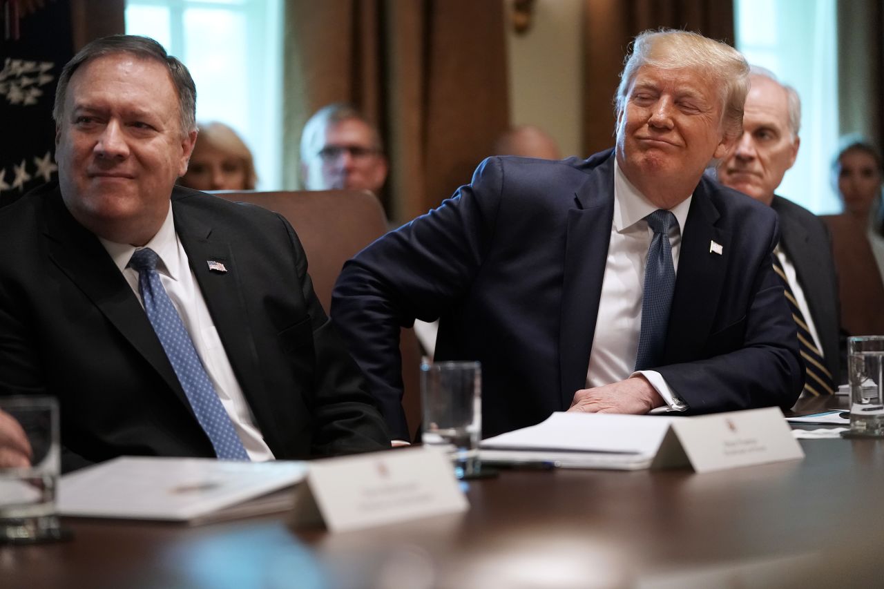 Trump and Secretary of State Mike Pompeo listen during a July 2019 cabinet meeting.