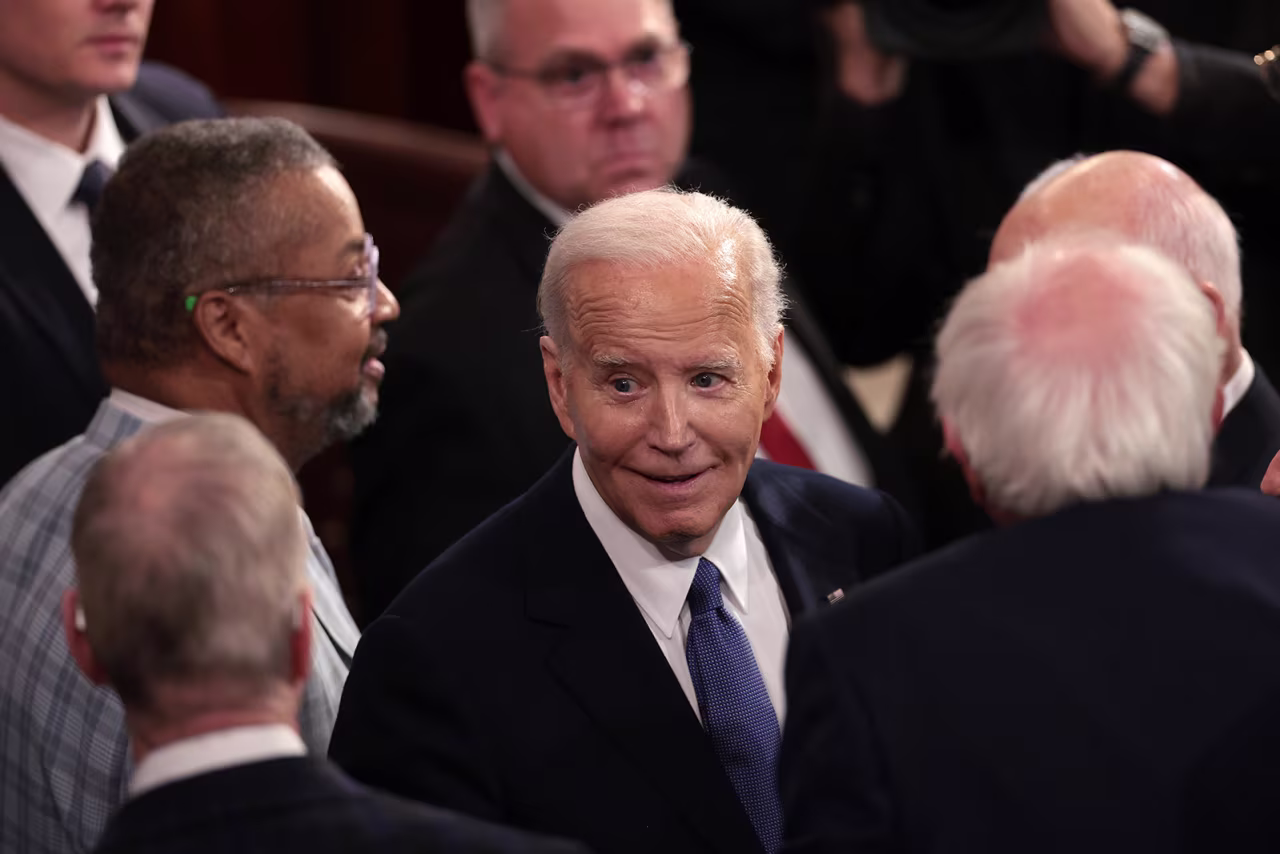 Biden greets members of Congress after his speech.