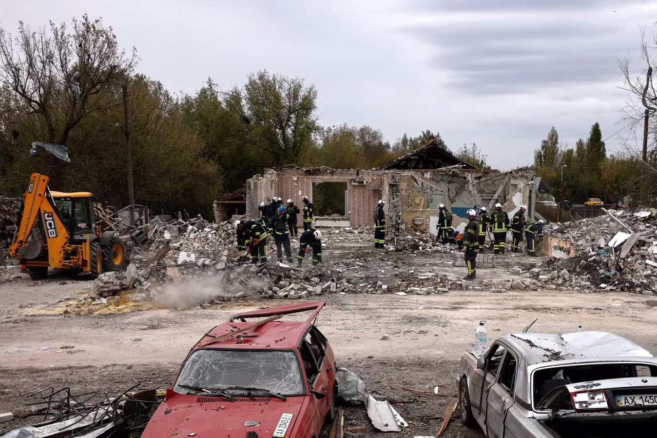 Emergency personnel work at a site of a Russian military strike in the village of Hroza, Kharkiv region, Ukraine, on October 6.
