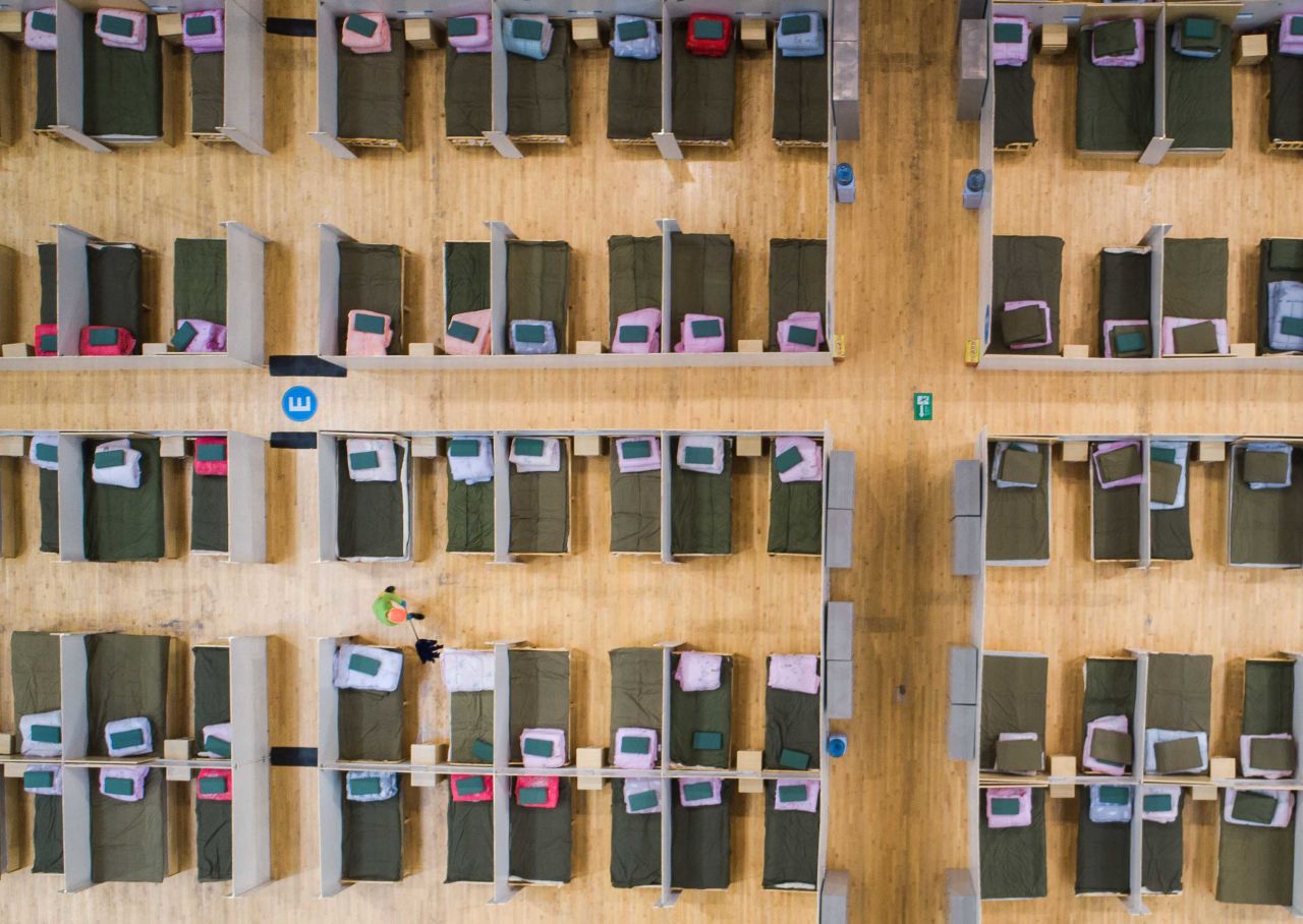 A worker cleans the floor between beds at a temporary hospital in Wuhan on February 12.