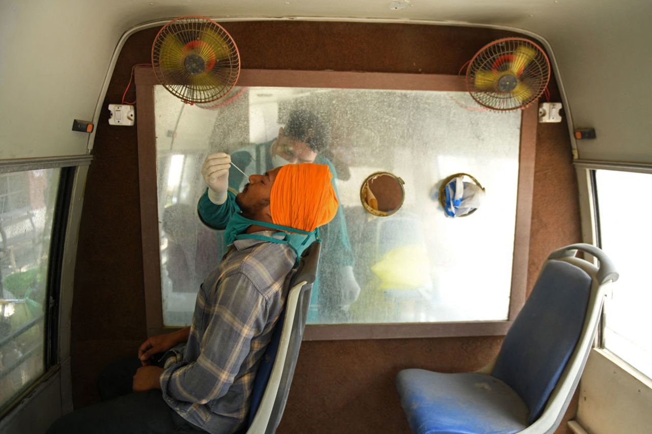 A health worker collects a nasal swab sample in a mobile testing van in Amritsar, India on May 24.