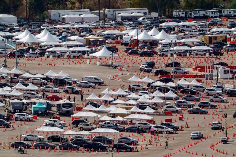 Drivers wait in line at a mega COVID-19 vaccination site set up in the parking lot of Dodger Stadium in Los Angeles on January 27.