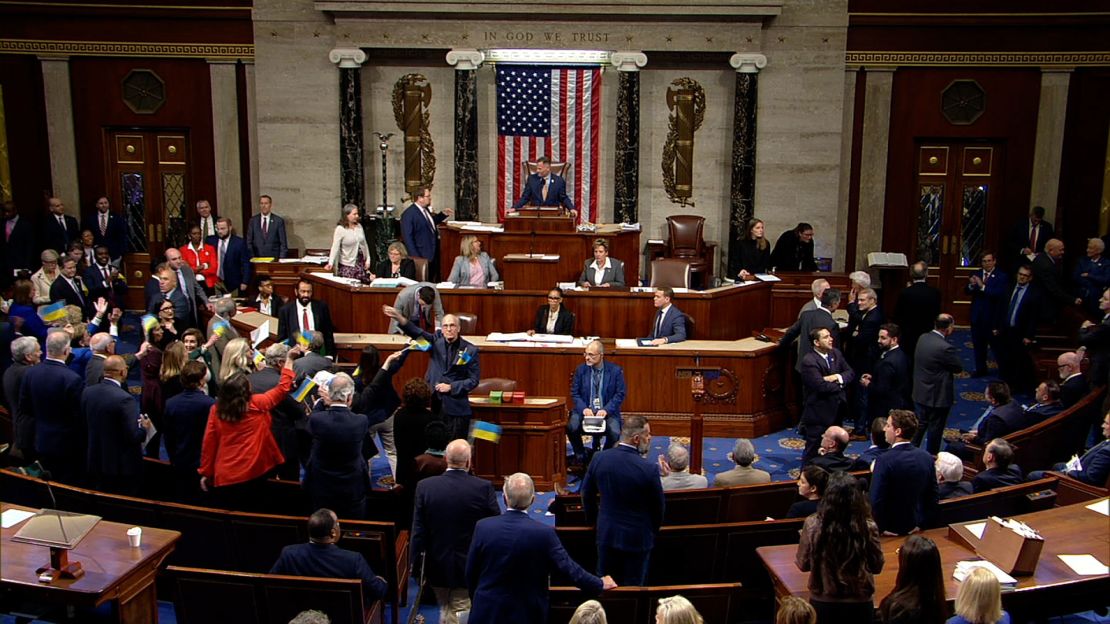 Democratic lawmakers wave Ukrainian flags after the House passed the Ukraine Security Supplemental Appropriations Act. 