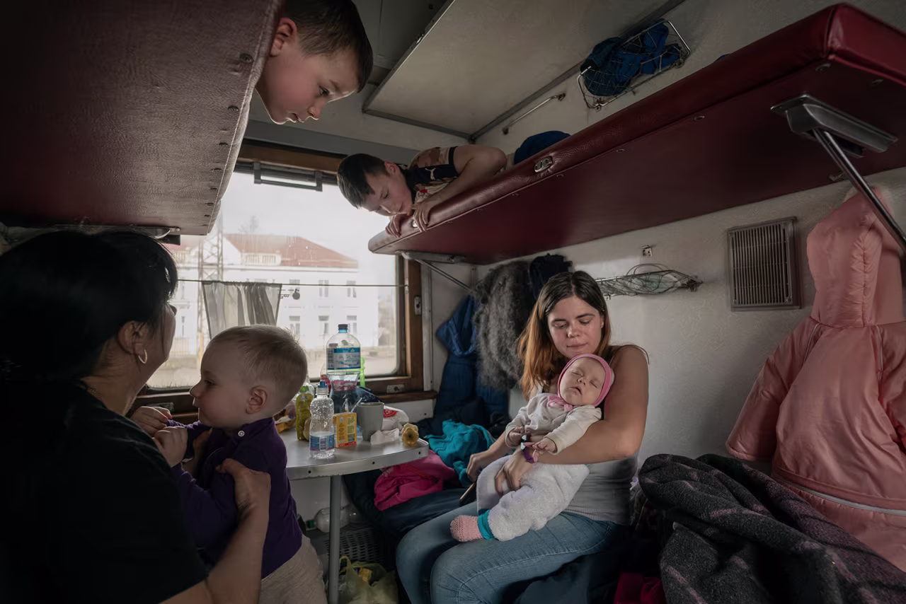 Inside an evacuation train, families travel in a carriage reserved for children with special needs. They were heading to Chop, a Ukrainian city near the Polish border.
