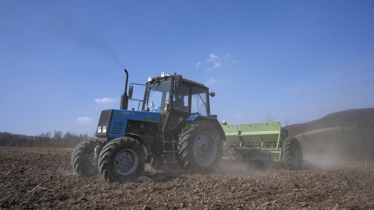 Workers plow wheat in the western village of Husakiv, Ukraine on Saturday, March 26.