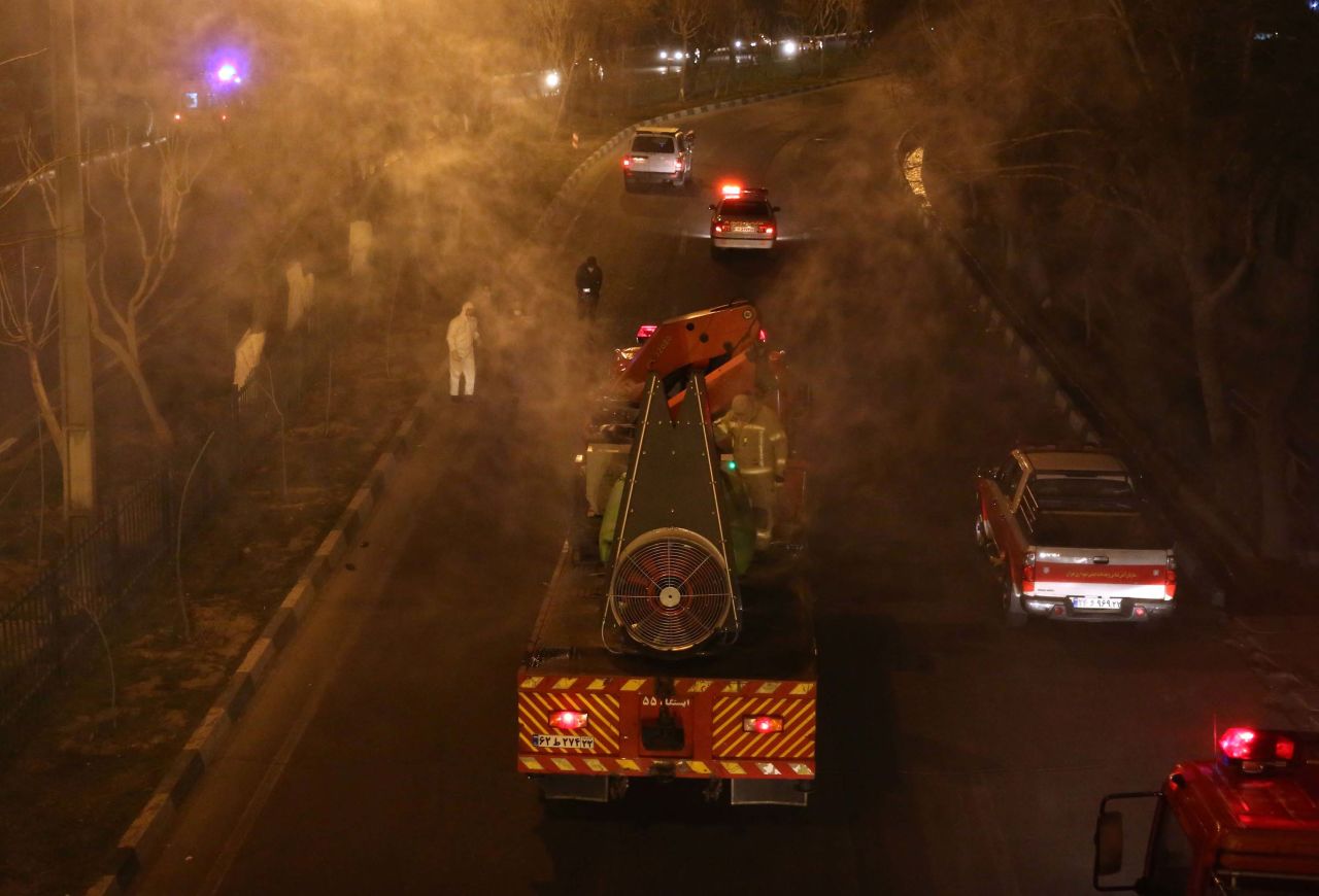 Iranian firefighters disinfect streets in Tehran, Iran, on Wednesday.