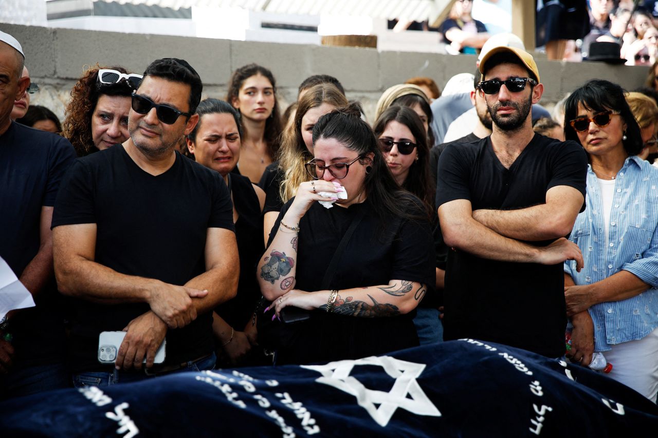 Family and friends mourn Danielle, 25, and Noam, 26, an?Israeli couple who were killed in a deadly attack as they attended a festival, as they are buried next to each other at their?funeral?in Kiryat Tivon,?Israel, on October 12.