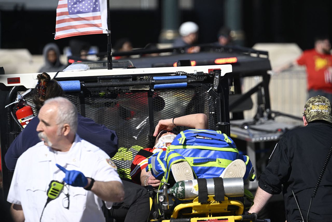 A victim is treated after shots were fired near the Kansas City Chiefs' Super Bowl LVIII victory rally on Wednesday in Kansas City, Missouri. 