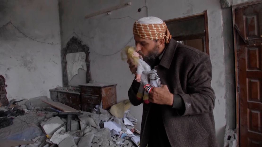 Khaled Nabhan kisses Reem's doll found in the rubble of his family's home on November 27.