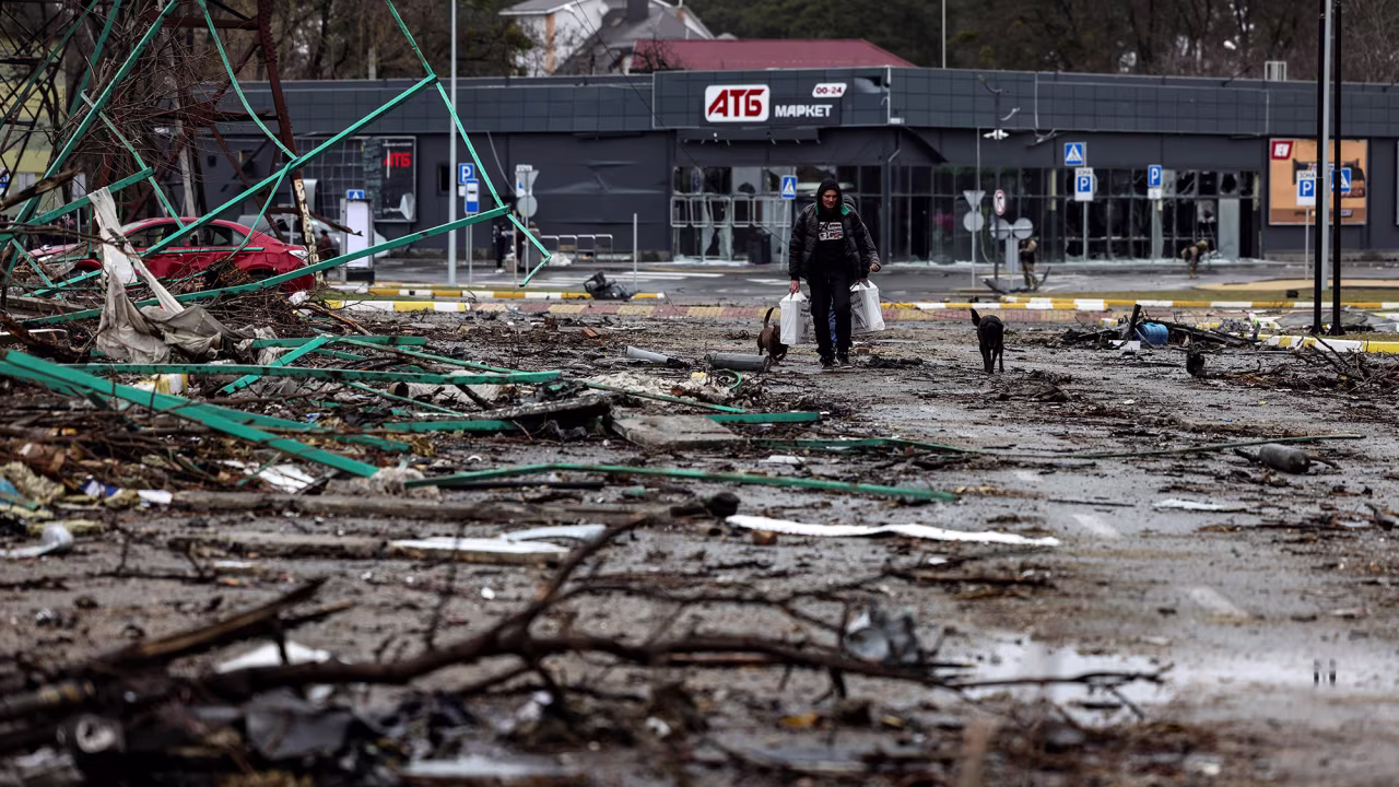 A man walks with bags of food given to him by the Ukrainian Army in Bucha, Ukraine on April 2.