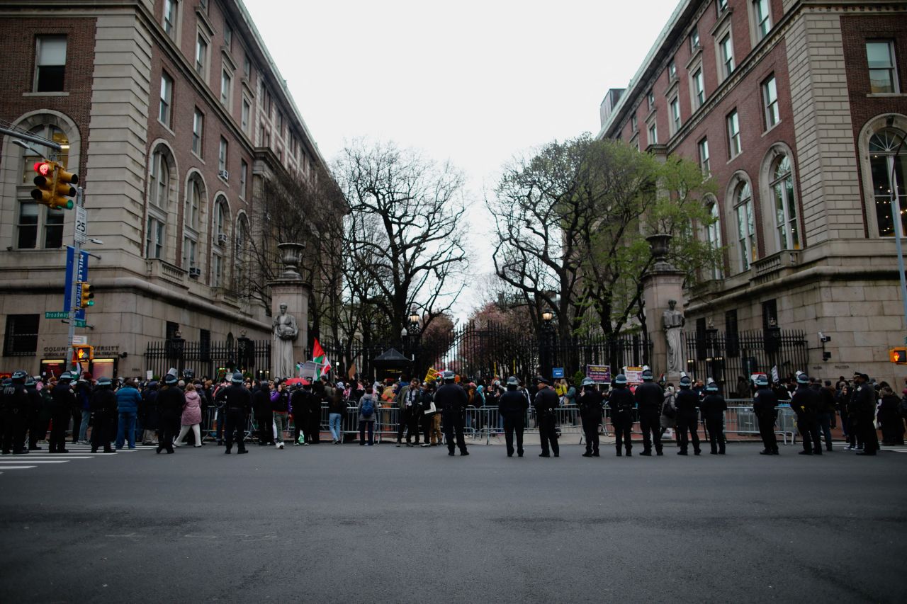 Police officers stand near barriers as pro-Palestinian protesters gather outside Columbia University in New York on April 18.