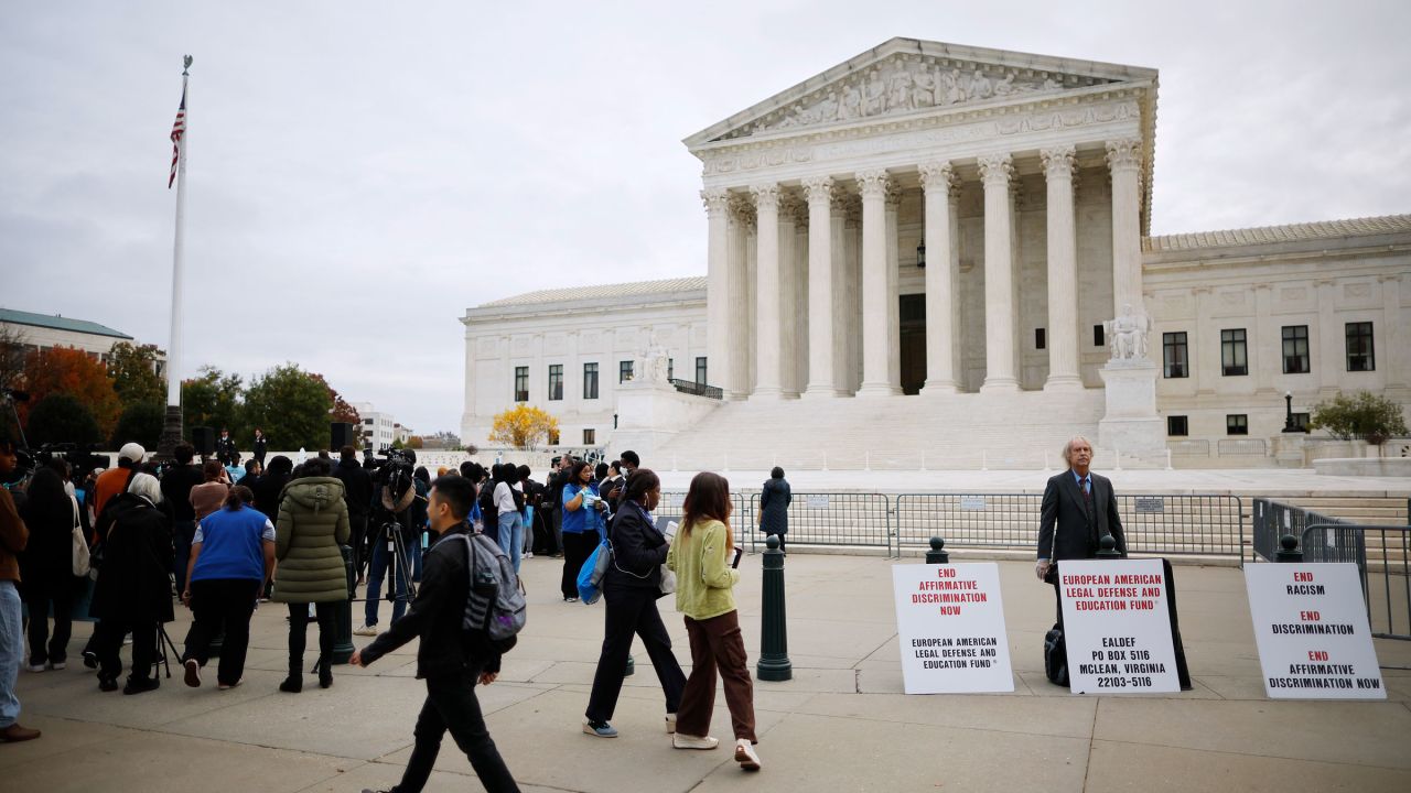 An opponent of affirmative action stands next to a rally of proponents on Monday.