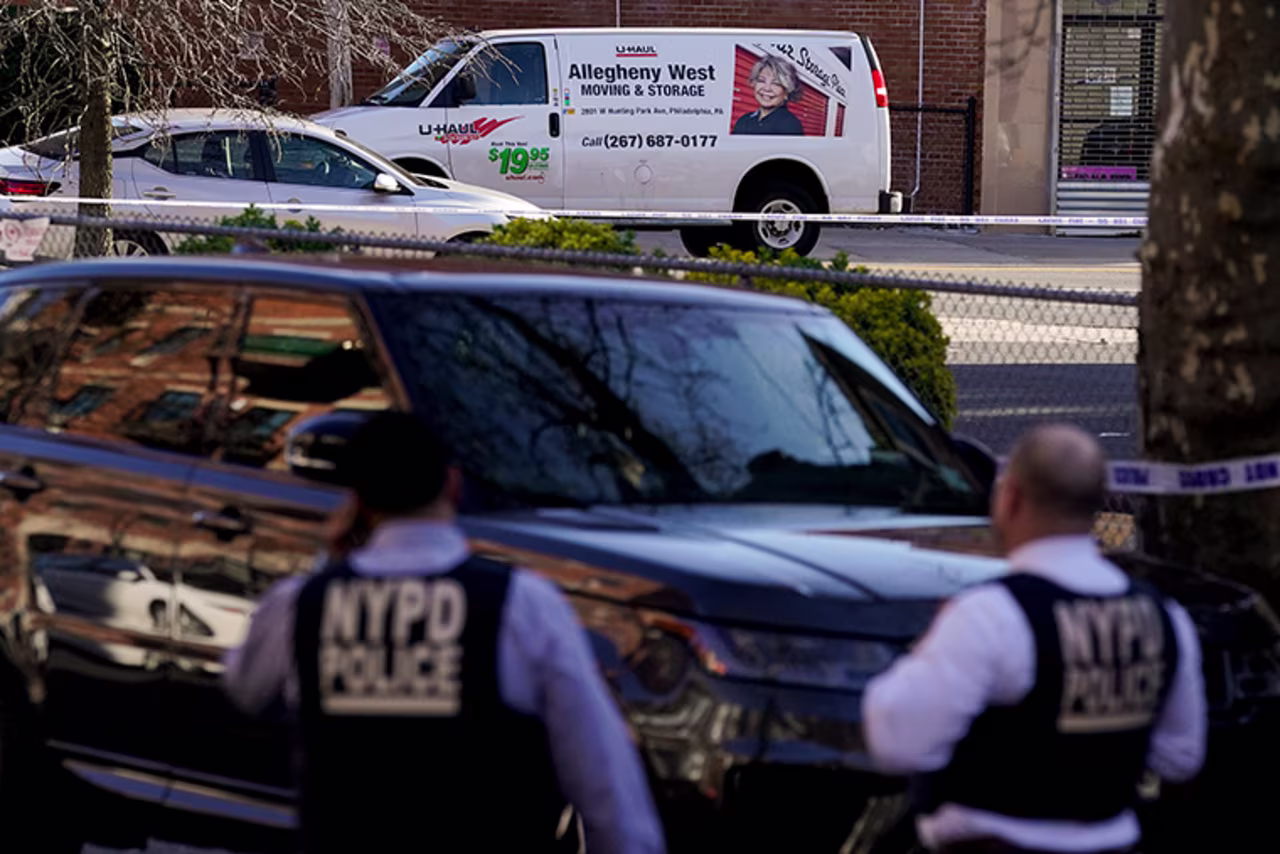 Emergency personnel form a perimeter around a U-Haul van in the Brooklyn borough of New York, Tuesday, April 12.