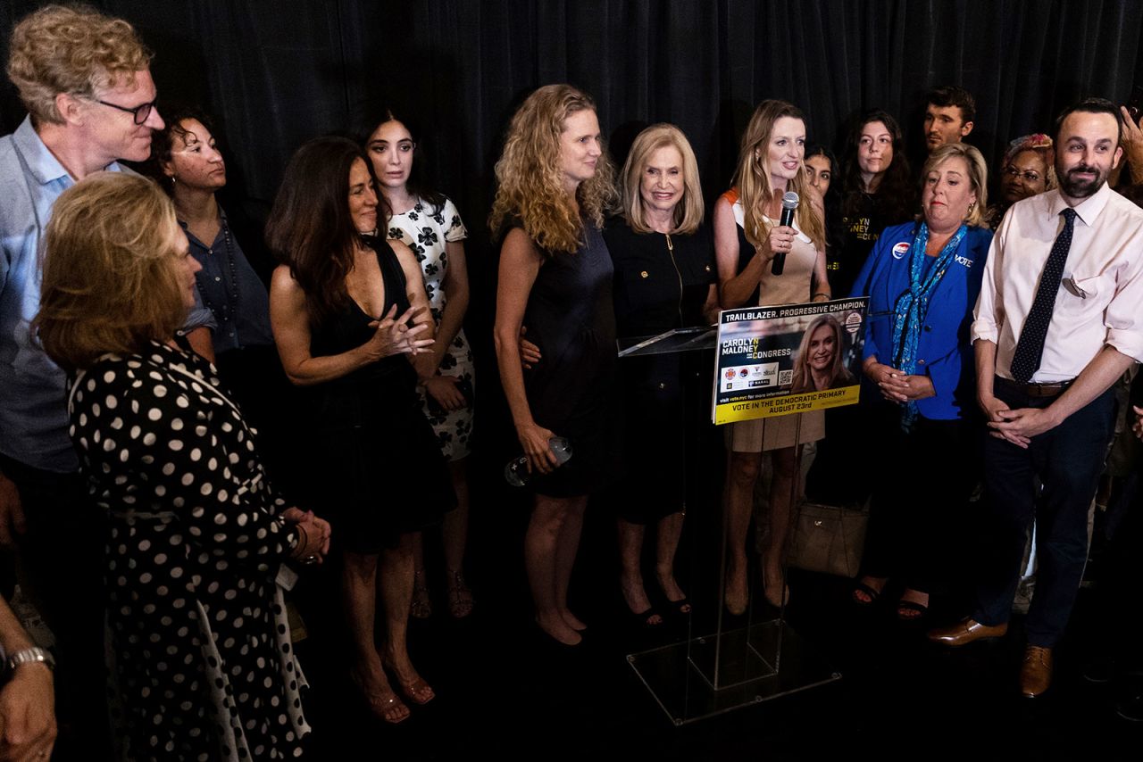 Rep. Carolyn Maloney, center, stands with family, staff and supporters at an election night party in New York on Tuesday.