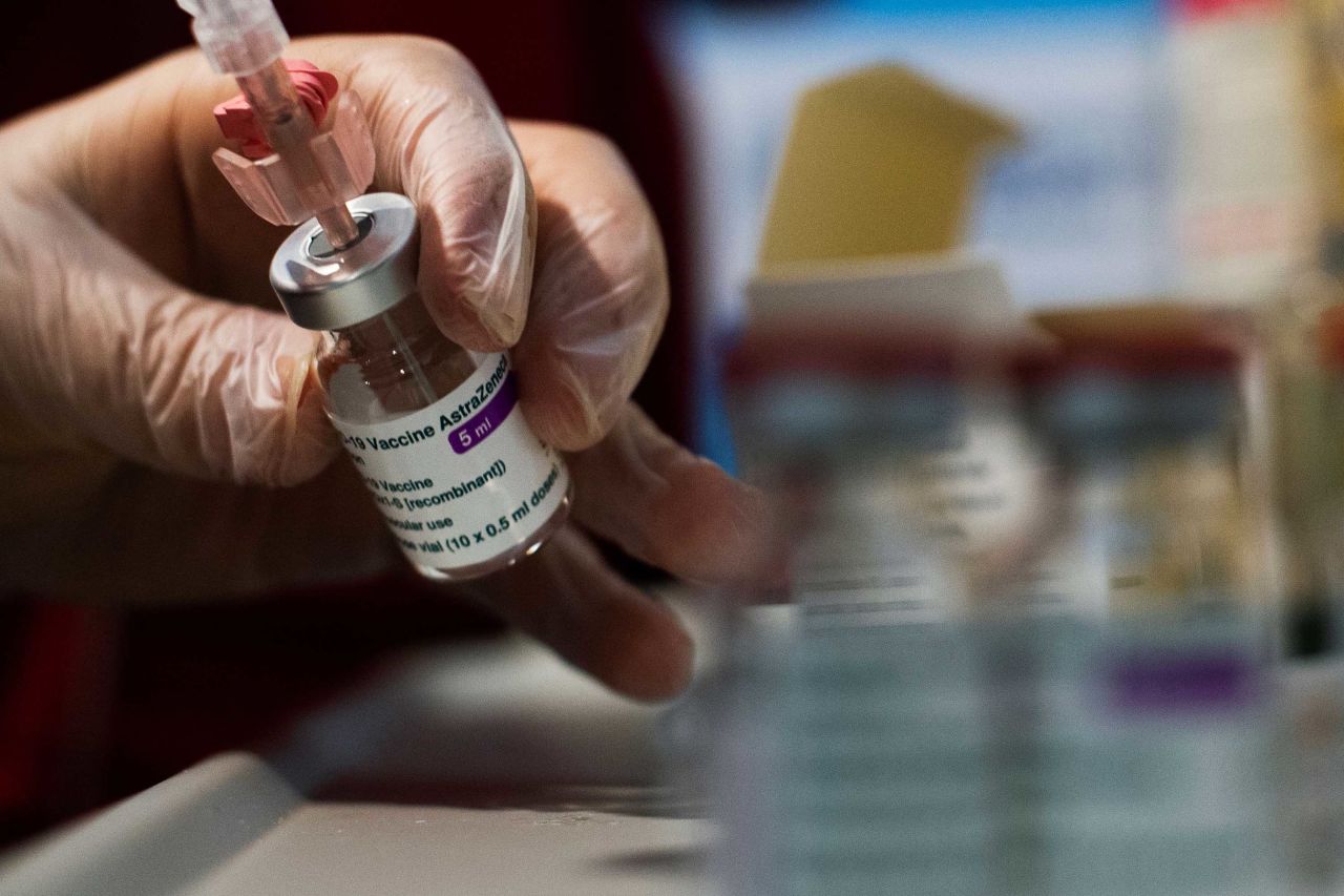 A Red Cross volunteer handles a dose of the AstraZeneca vaccine at a vaccine hub in Rome's Fiumicino airport parking area on February 11.