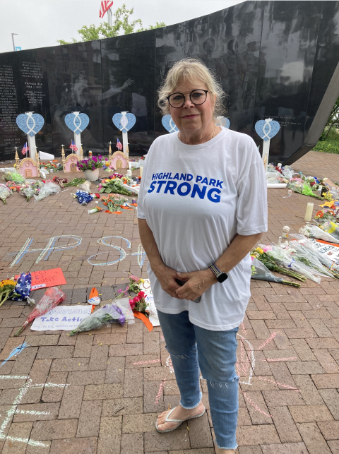 Karen Abrams at a Veteran's Memorial Park turned into a memorial for those killed in the 4th of July parade shooting.