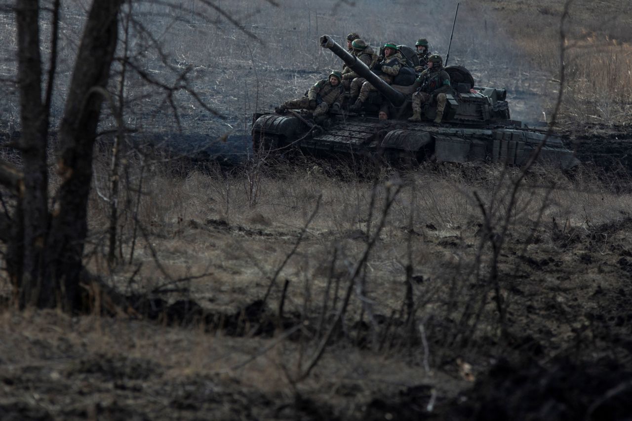 Ukrainian service members ride atop a tank near Bakhmut on March 4. 