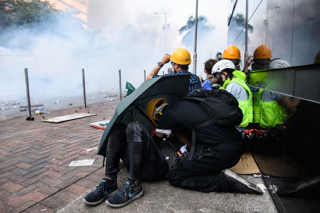 Protesters huddle as police fire tear gas in Hong Kong Polytechnic University on November 18, 2019. 