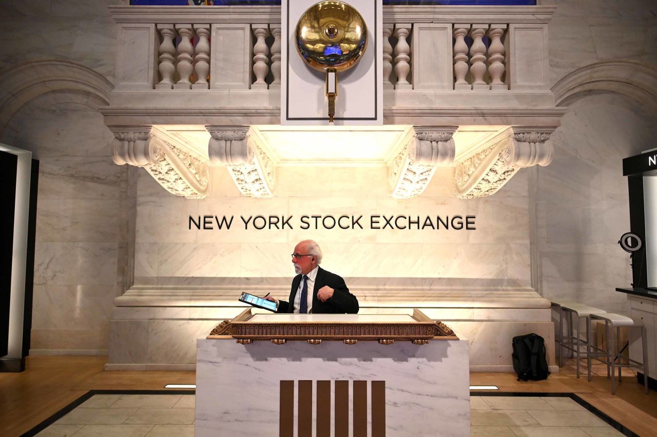 A trader works during the opening bell at the New York Stock Exchange on March 16. Trading on Wall Street was halted immediately after the opening bell Monday, as stocks posted steep losses following emergency moves by the Federal Reserve to try to avert a recession due to the coronavirus pandemic.