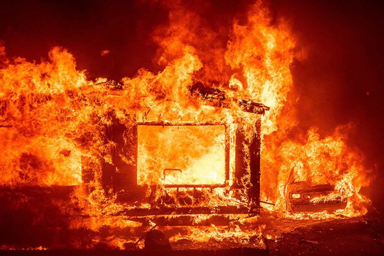 A mobile home and car burn at Spanish Flat Mobile Villa as the LNU Lightning Complex fires tear through unincorporated Napa County, Calif., on Tuesday, Aug. 18, 2020. 