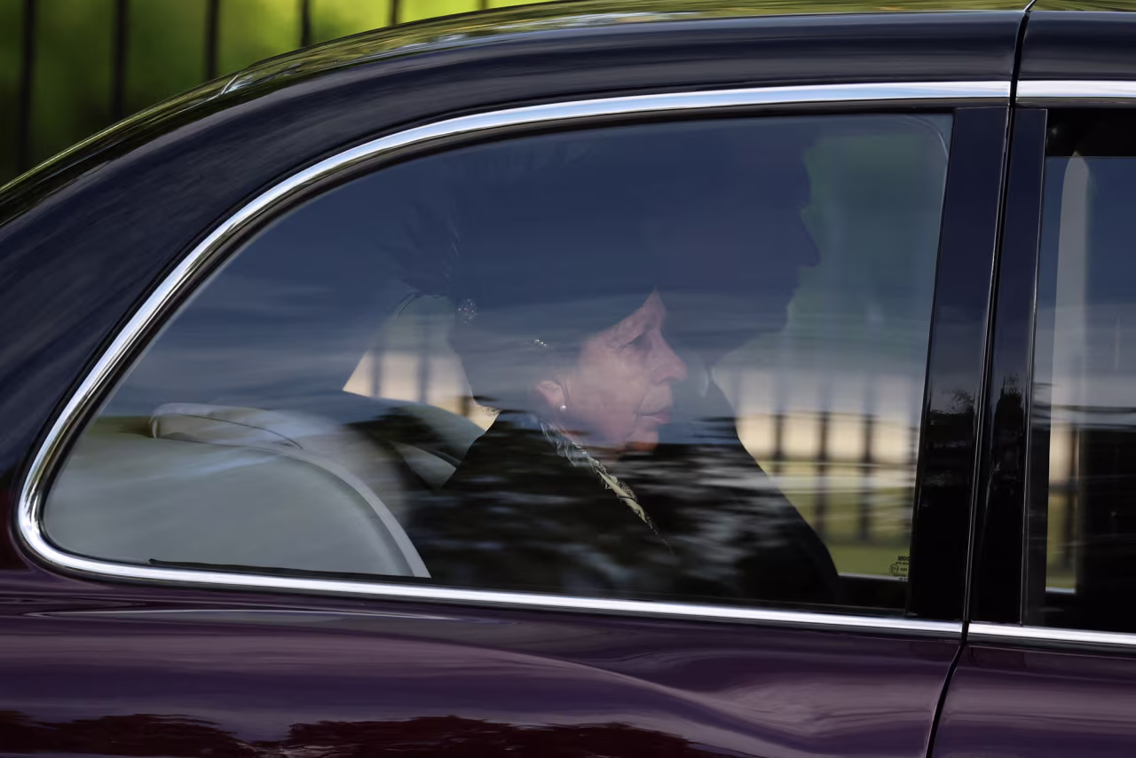 The Queen's daughter, Princess Anne, accompanies the hearse carrying her mother's coffin as it departs Balmoral Castle.