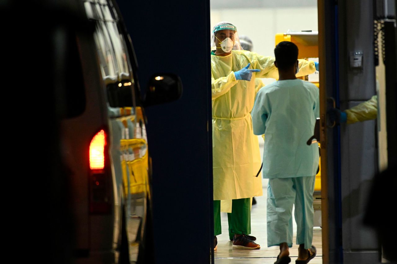 Medical staff prepare for patients to be transferred to a temporary hospital in Singapore on April 10.