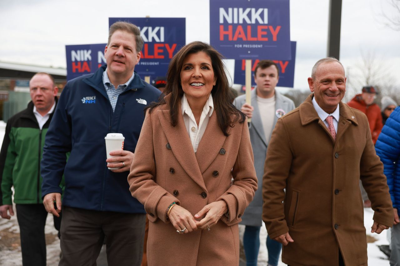 Haley is joined by New Hampshire Gov. Chris Sununu as they visit a polling location at Winnacunnet High School to greet voters on January 23, 2024, in Hampton, New Hampshire. 