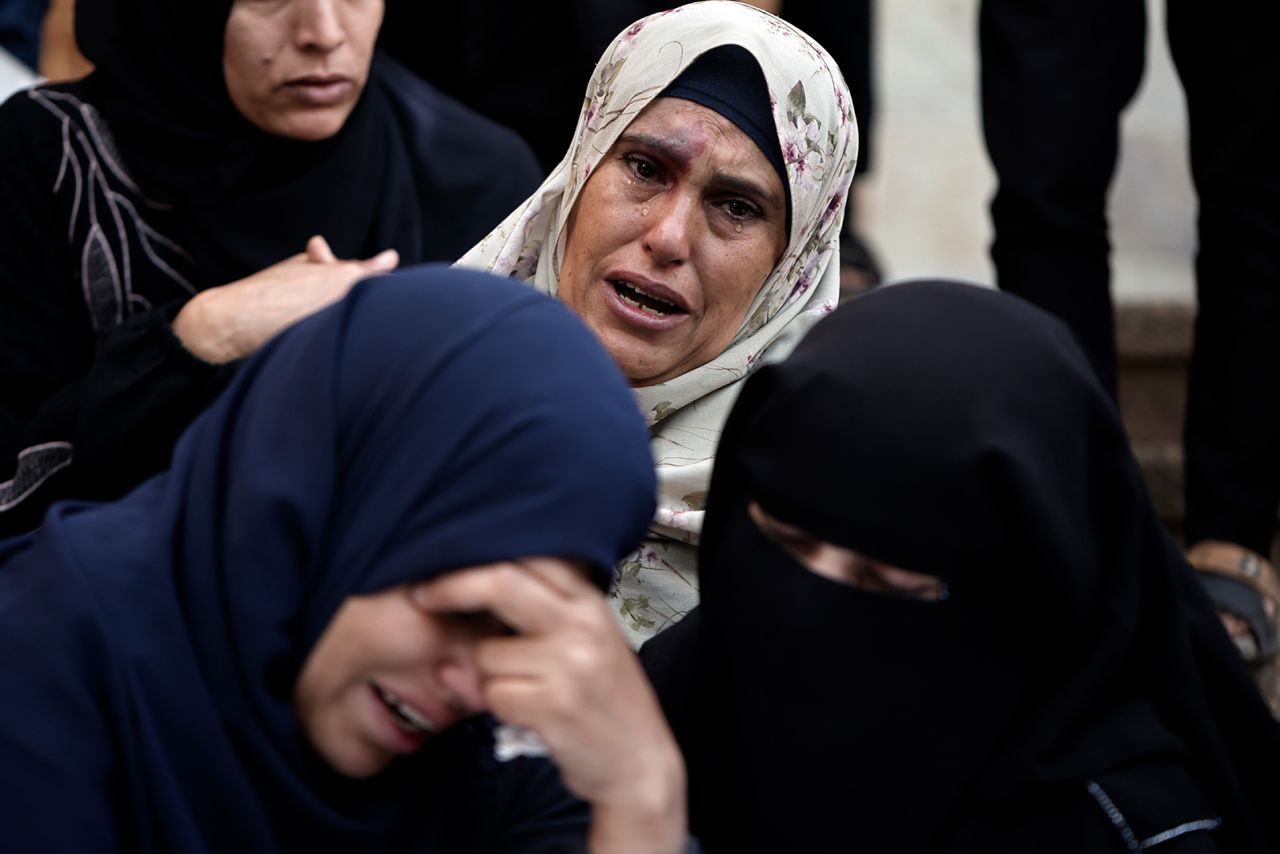 Palestinians mourn relatives killed in the Israeli bombardment of Gaza outside a morgue in Khan Younis on December 10. 