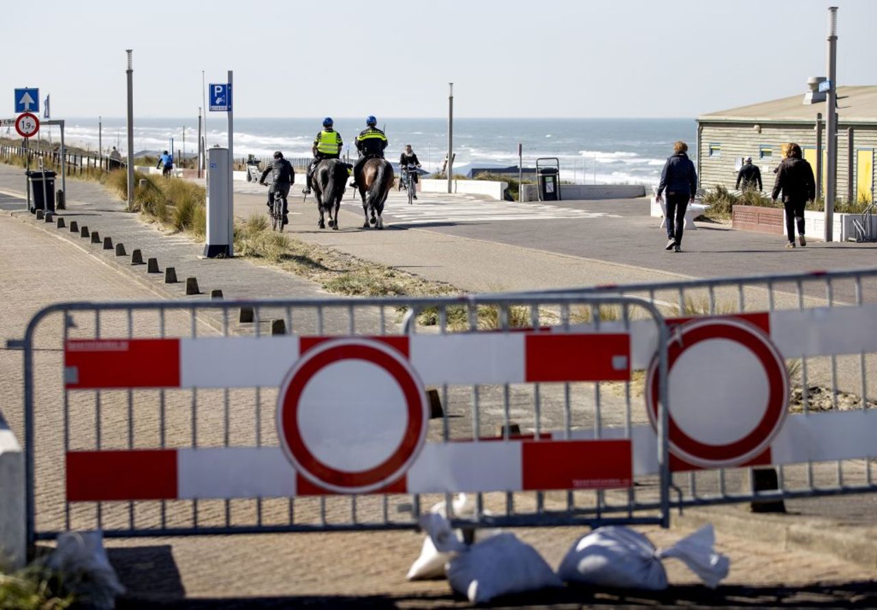 Police on horseback patrol on the boulevard along the beach in Zandvoort on April 4, amid the outbreak of Covid-19