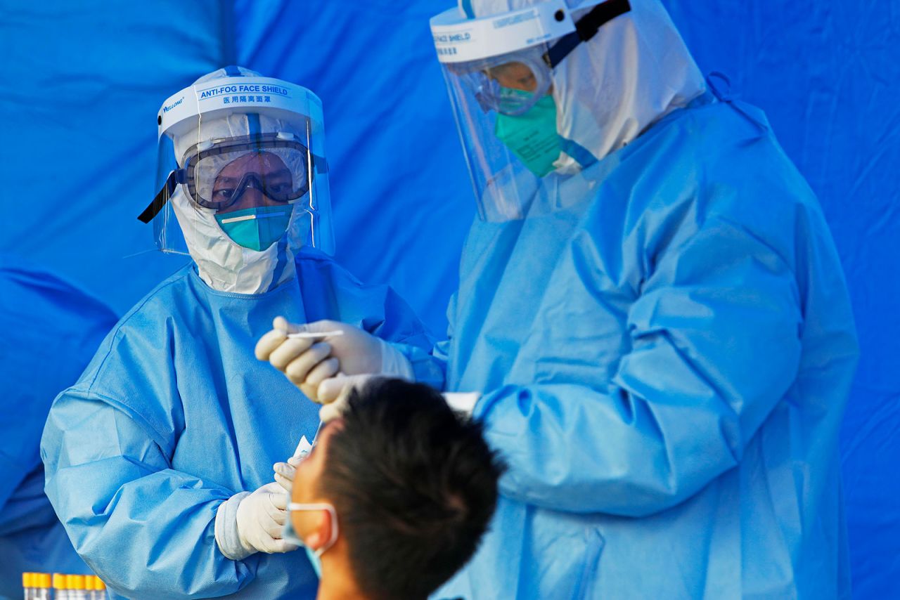 Medical workers administer a coronavirus test at East China Normal University in Shanghai on May 9.