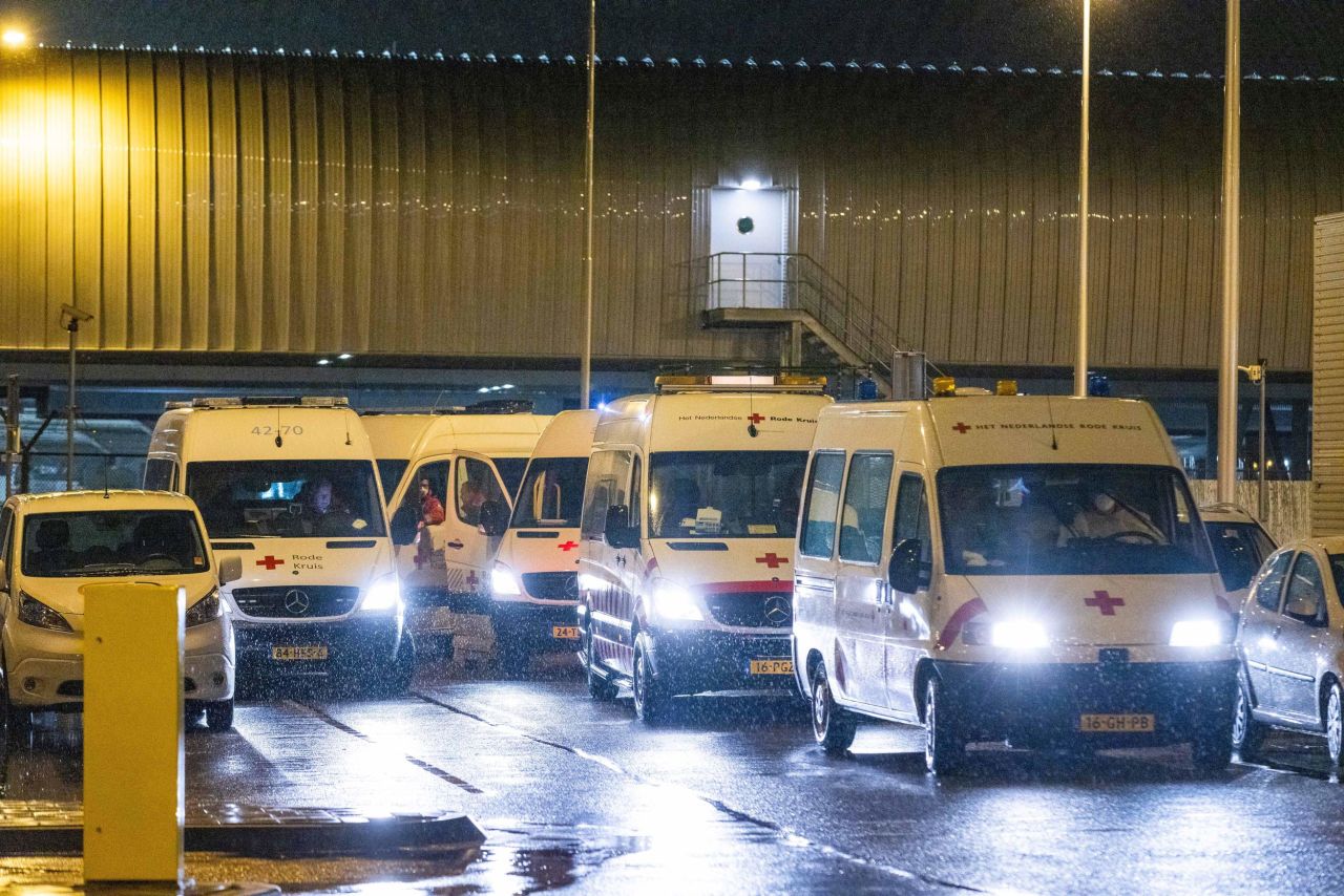 Red Cross workers transport passengers infected with coronavirus returning from South Africa for quarantine at a hotel in Schiphol, Netherlands, on November 27. 