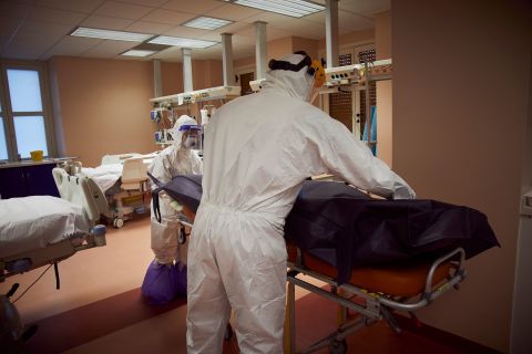 Health care personnel transport a deceased patient in an intensive care unit on November 18 in Palermo, Italy.
