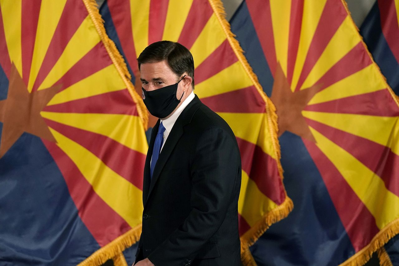 Arizona Republican Gov. Doug Ducey arrives for a news conference to talk about the latest Arizona V-19 information Wednesday, Dec. 2, 2020, in Phoenix. (AP Photo/Ross D. Franklin, Pool)