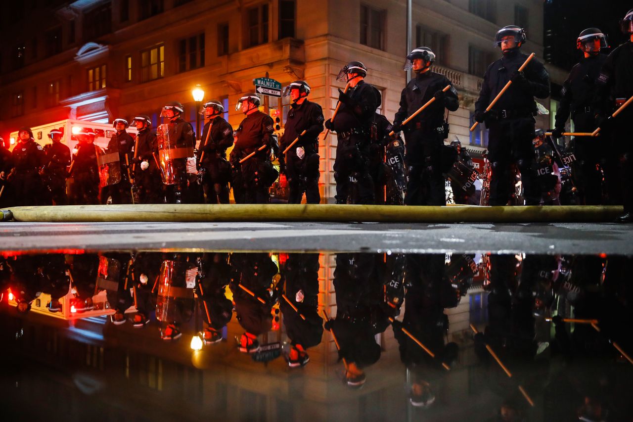 Police stand guard in Philadelphia on Saturday night.