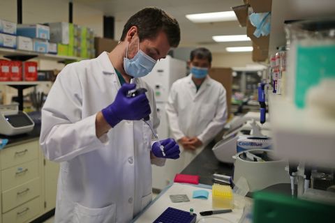 In this August 5 file photo, a lab technician prepares a solution that will be used to process coronavirus test samples at Advagenix, a molecular diagnostics laboratory, in Rockville, Maryland. 