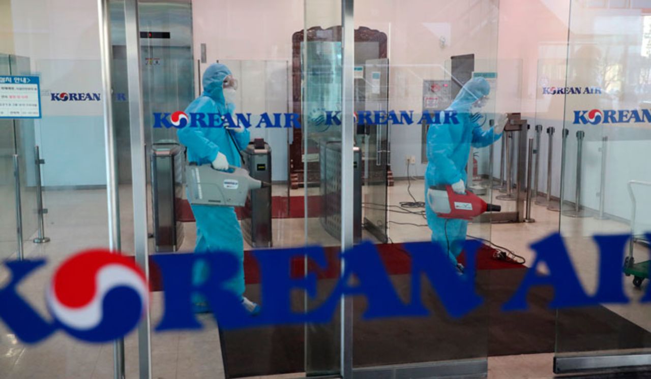 Workers wearing protective gears spray disinfectant as a precaution against the new coronavirus at Korean Air's Incheon Operation Center at Yeongjong Island, South Korea, Tuesday, February 25.