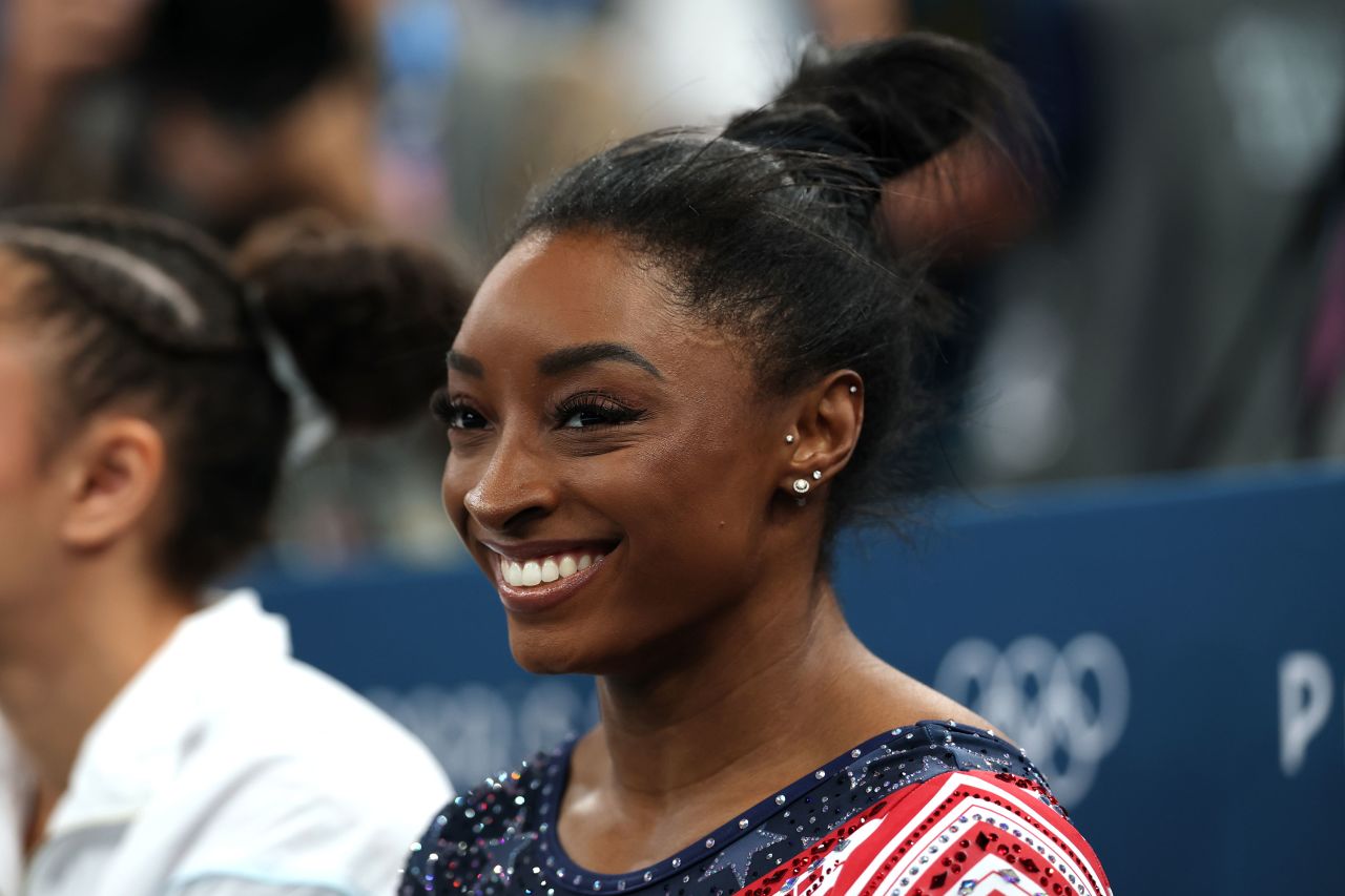 Simone Biles smiles reacts during the gymnastics women's team final on Tuesday.