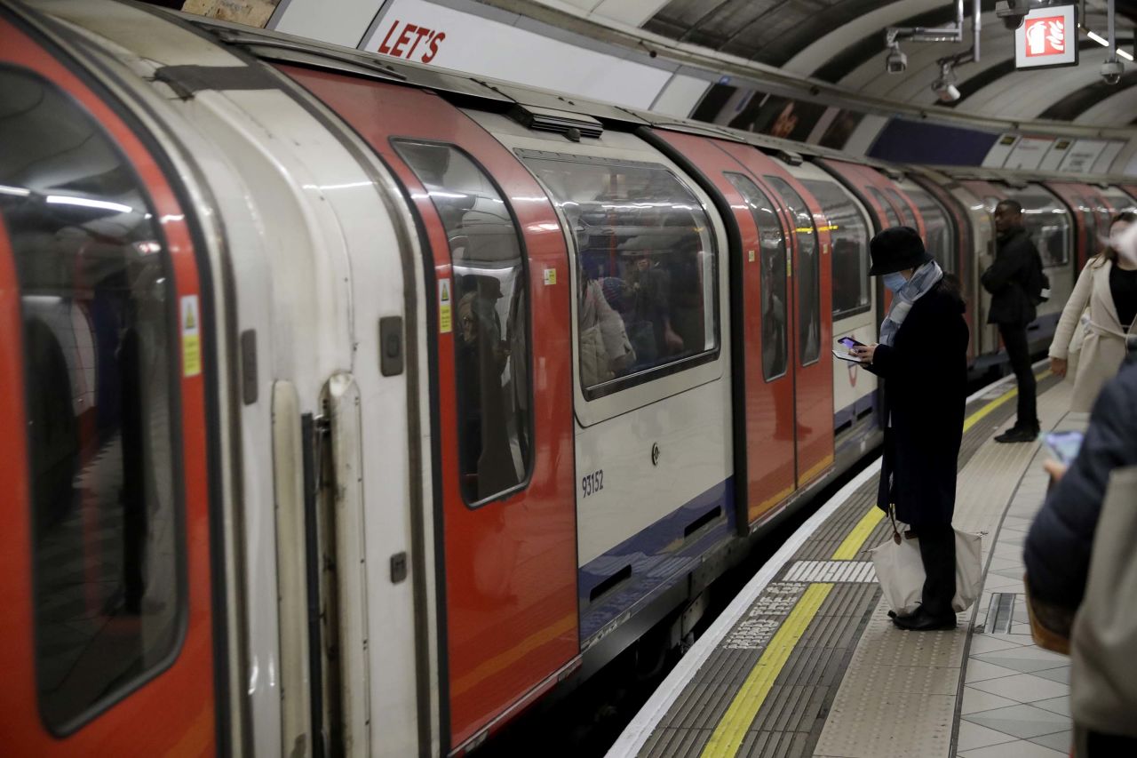 A passenger wears a face mask while waiting to board an underground train in London on Wednesday.