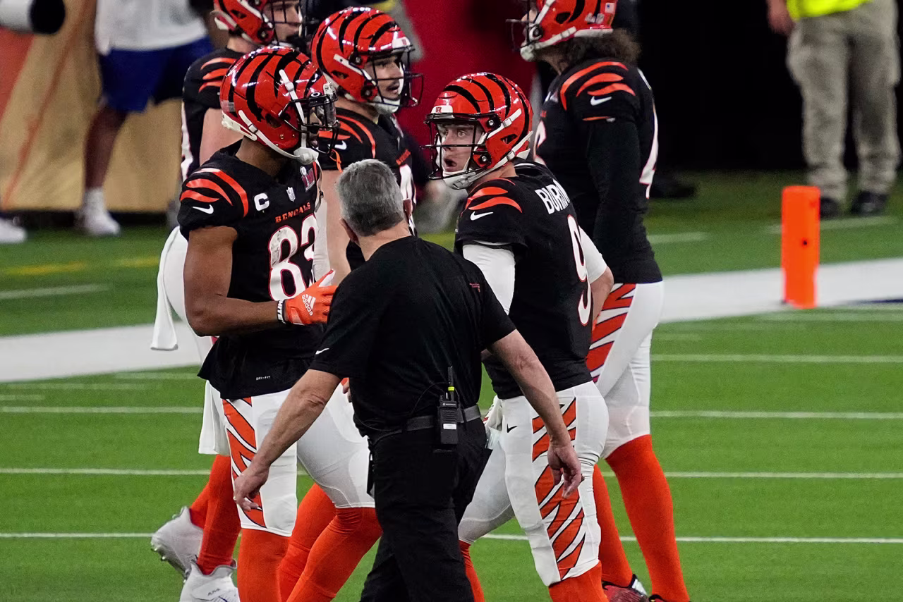 Cincinnati Bengals quarterback Joe Burrow walks off the field after being injured on a sack.