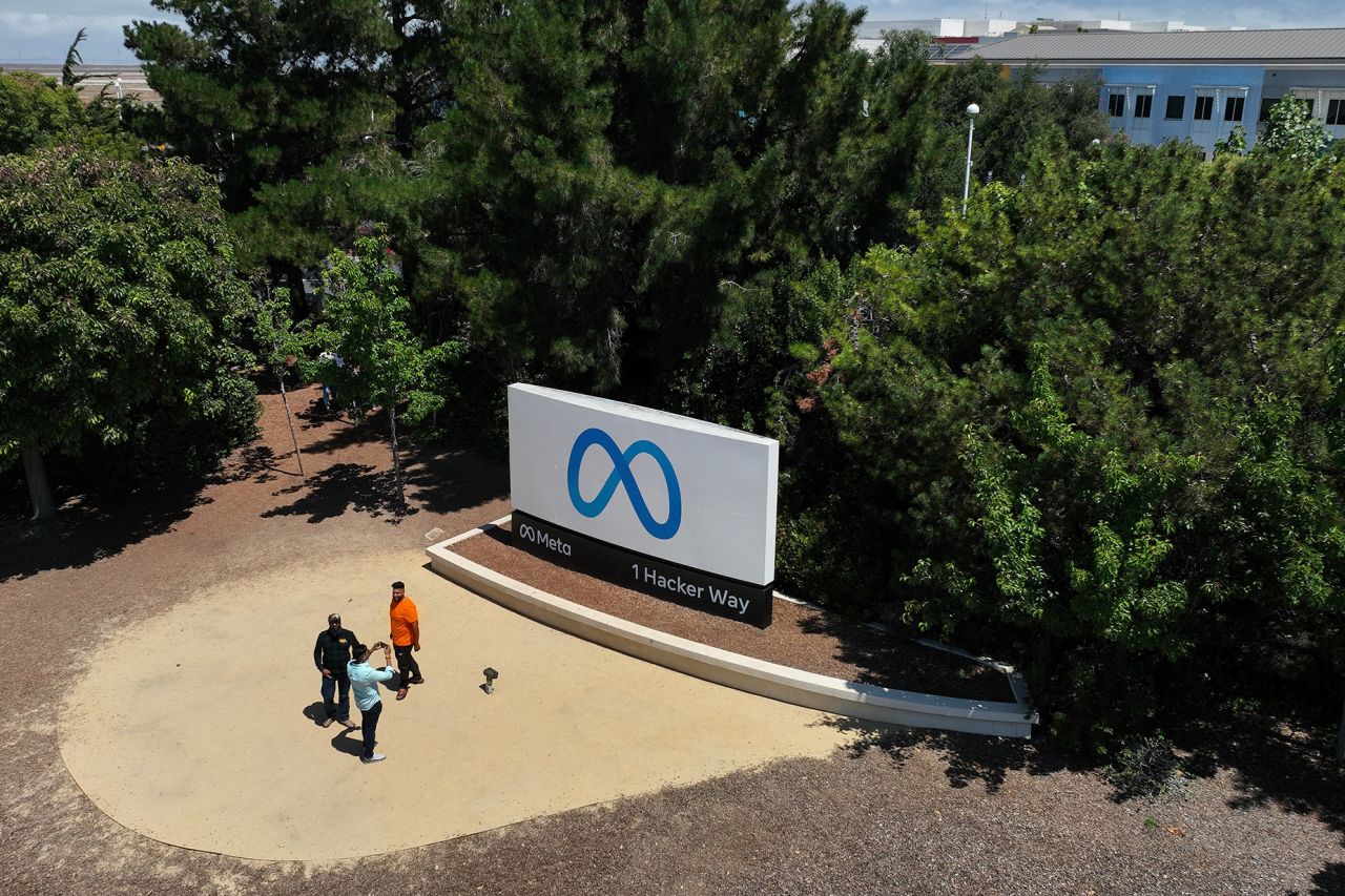 In an aerial view, people gather near the Meta headquarters sign, in Menlo Park, California, in July 2023.