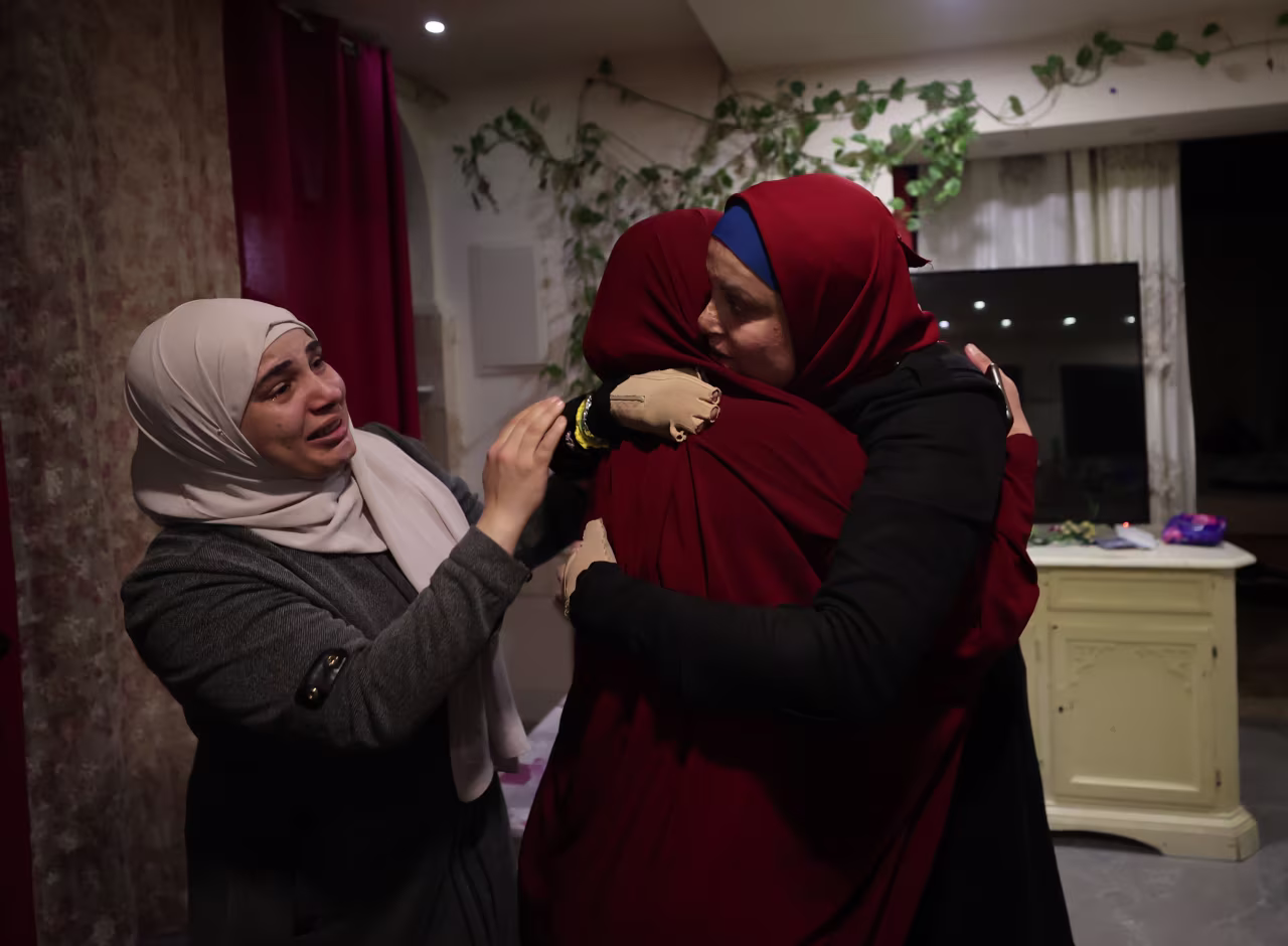 Israa Al-Jaabis reunites with her family in East Jerusalem early Sunday after being released from an Israeli prison. 