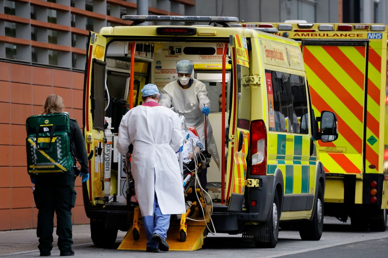 Medics take a patient from an ambulance into a London hospital on Tuesday.  